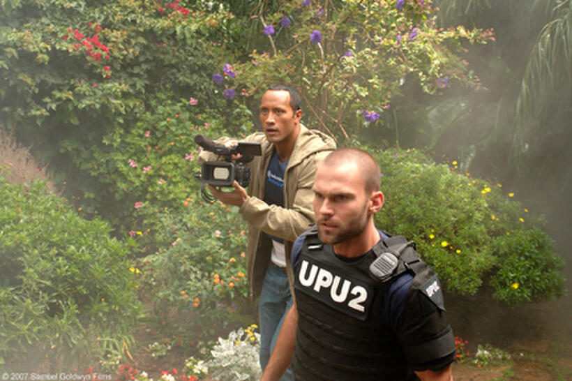 Dwayne Johnson as Boxer Santaros and Seann William Scott as Roland Taverner-Ronald Taverner in "Southland Tales."