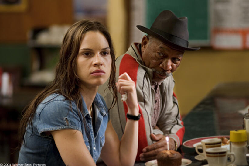 HILARY SWANK as Maggie and MORGAN FREEMAN as Scrap in Warner Bros. Pictures' drama "Million Dollar Baby." The Malpaso production also stars Clint Eastwood.
