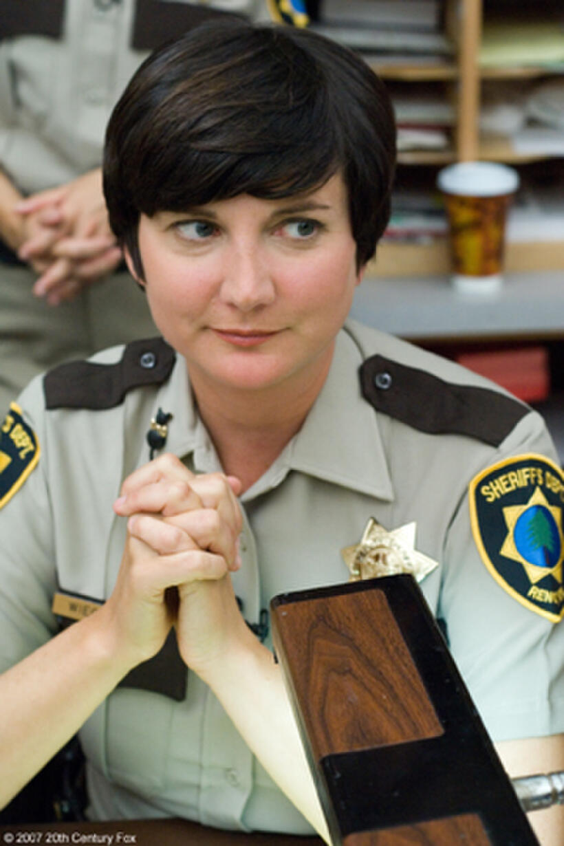 Dep. Trudy Wiegel (Kerri Kenney-Silver) listens attentively at the daily morning meeting of the Reno Sheriff's Dept. in "Reno 911!: Miami."
