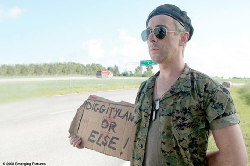 A disgruntled former theme park employee (Alan Cumming in the role of the Hitchhiker) waits for a ride in "Full Grown Men."