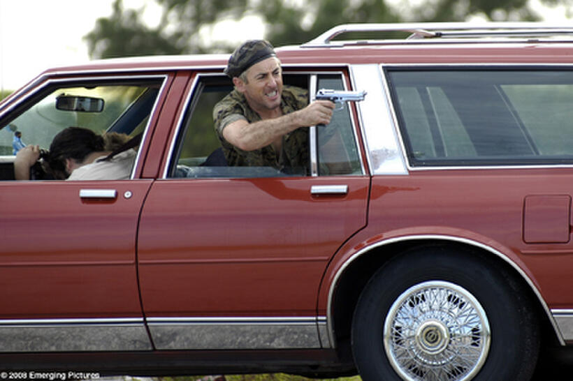 An erratic Hitchhiker (Alan Cumming) terrifies our main characters with a malfunctioning weapon in "Full Grown Men."