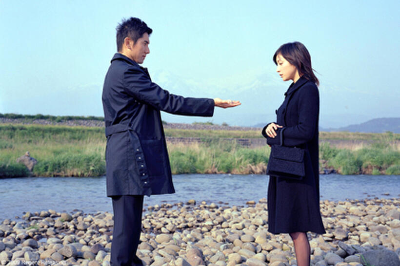 Masahiro Motoki as Daigo Kobayashi and Ryoko Hirosue as Mika Kobayashi in "Okuribito."