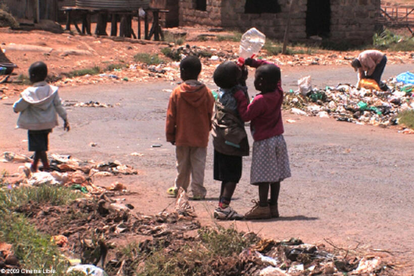 Children play with an empty water bottle in "The End of Poverty?"