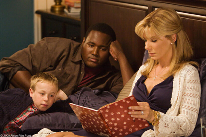 Jae Head as S.J., Quinton Aaron as Michael Oher and Sandra Bullock as Leigh Anne Tuohy in "The Blind Side."