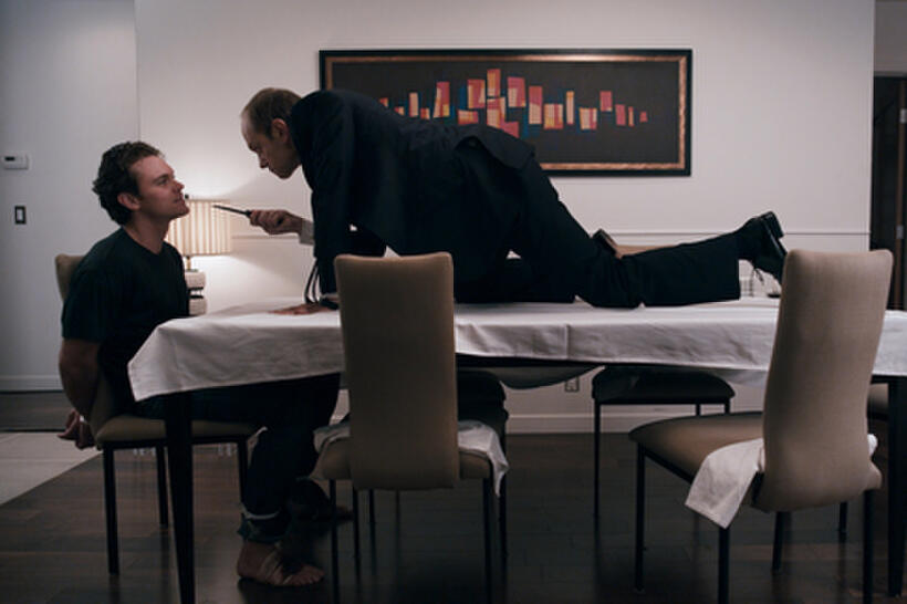Clayne Crawford as John Taylor and David Hyde Pierce as Warwick Wilson in ``The Perfect Host.''