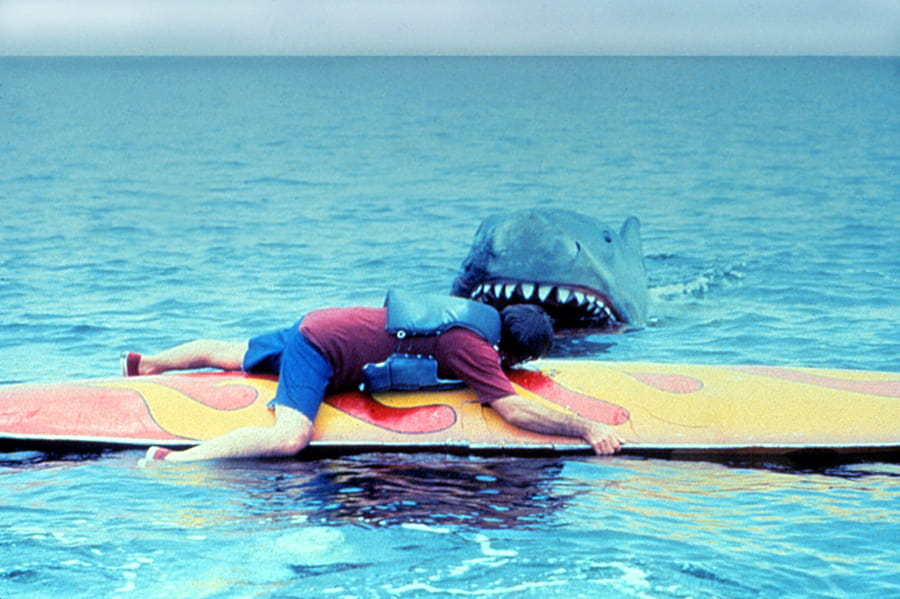 Man on a surfboard about to be eaten by a shark in Jaws 2